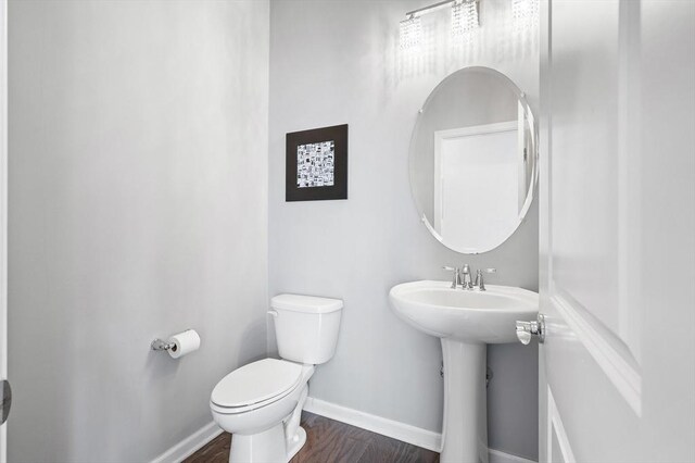 19 Locust Ln Unit 19, Hopkinton, MA 01748 - half bath featuring toilet, baseboards, wood finished floors, and a sink