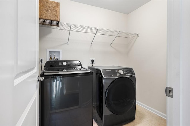 19 Locust Ln Unit 19, Hopkinton, MA 01748 - washroom with washing machine and clothes dryer, baseboards, and light tile patterned flooring