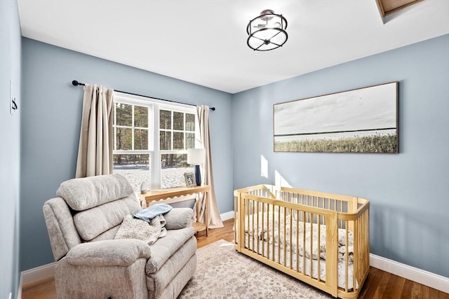 bedroom featuring baseboards and wood finished floors