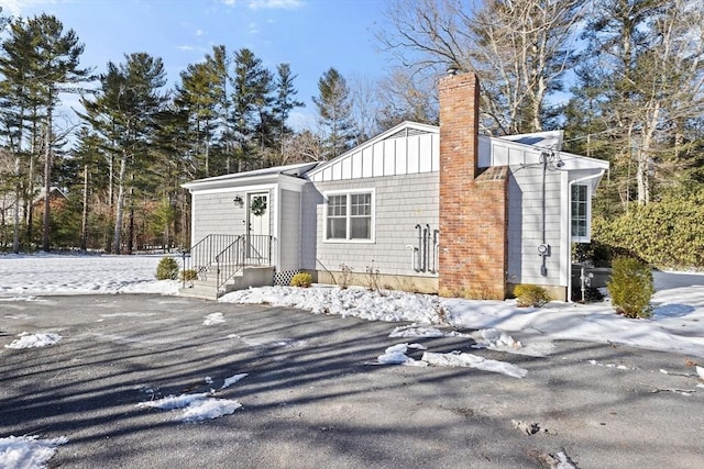 view of front of home featuring board and batten siding and a chimney