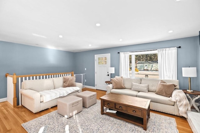 living area with light wood finished floors, recessed lighting, and baseboards