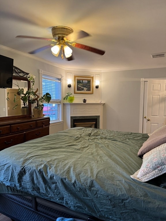 bedroom with ceiling fan and crown molding