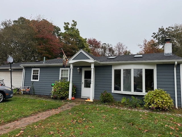 view of front of home with a garage and a front lawn