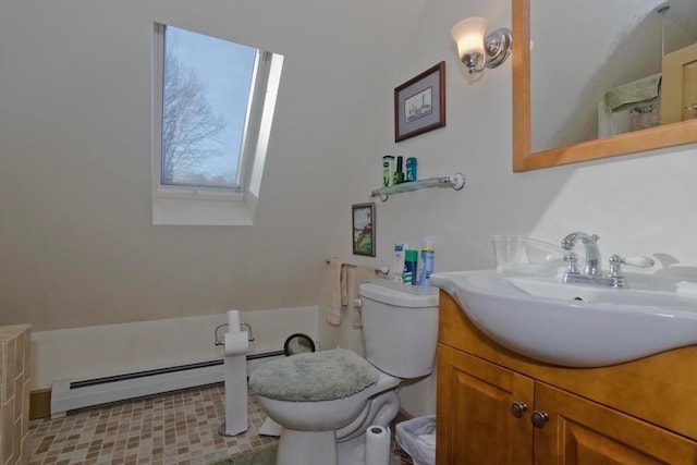 bathroom featuring a baseboard radiator, vanity, toilet, and a skylight