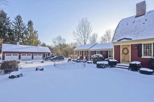 yard covered in snow featuring a garage