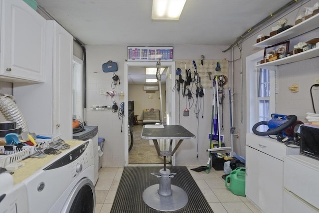 laundry area with washer / clothes dryer and light tile patterned floors