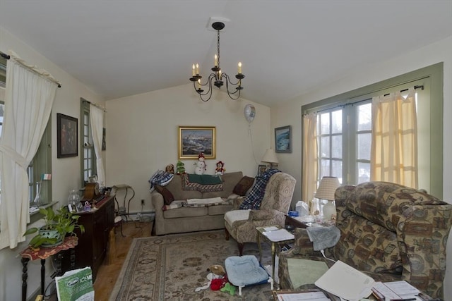 living room featuring hardwood / wood-style flooring, a baseboard heating unit, vaulted ceiling, and a notable chandelier