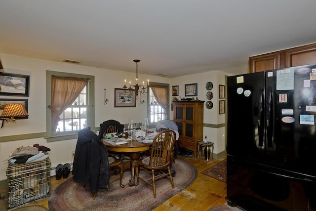 dining room featuring hardwood / wood-style floors and a notable chandelier