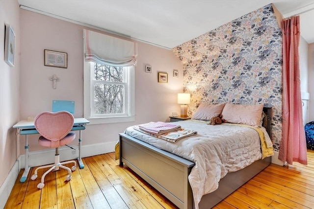 bedroom featuring baseboards and wood-type flooring