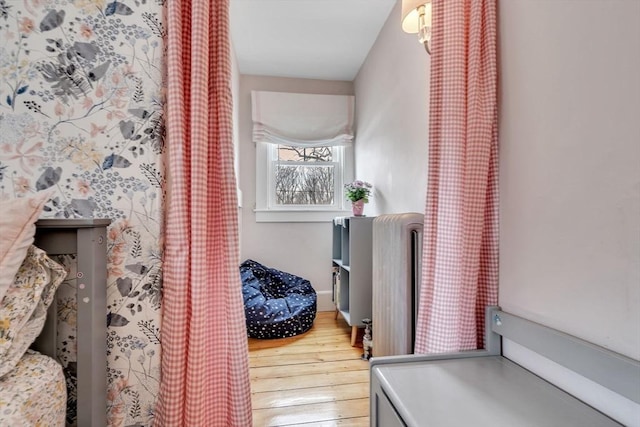 corridor featuring hardwood / wood-style floors and radiator heating unit