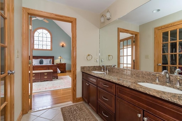 bathroom with lofted ceiling, vanity, and tile patterned floors