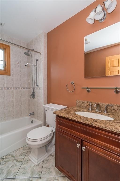 full bathroom featuring toilet, vanity, and tiled shower / bath combo