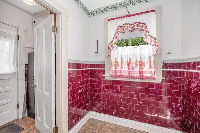 bathroom with a wainscoted wall