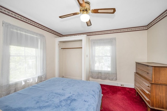 carpeted bedroom with a ceiling fan and baseboards
