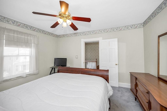 carpeted bedroom with baseboards and a ceiling fan