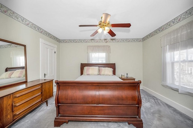 bedroom featuring baseboards, ceiling fan, and carpet