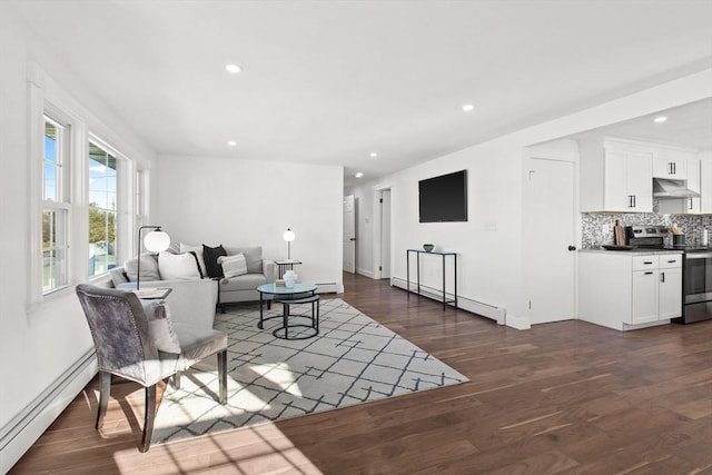 living room with baseboard heating and dark wood-type flooring