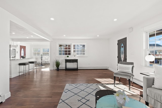 living room with dark hardwood / wood-style floors and a baseboard radiator