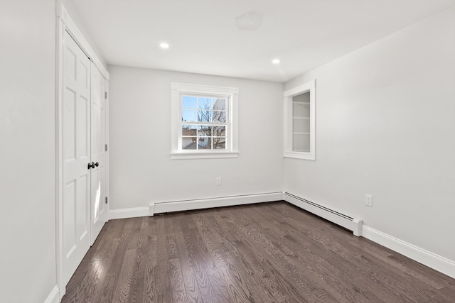 unfurnished bedroom with a closet and dark wood-type flooring