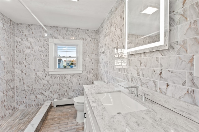 bathroom with toilet, a baseboard radiator, tile walls, and tiled shower