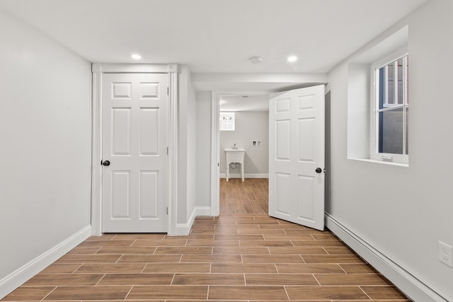 hallway featuring a baseboard heating unit