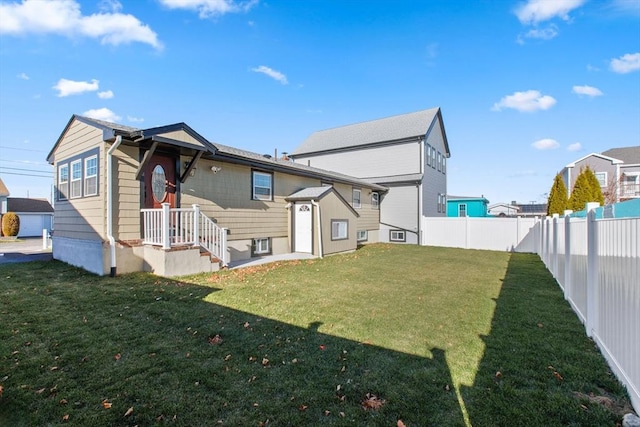 rear view of property with a yard