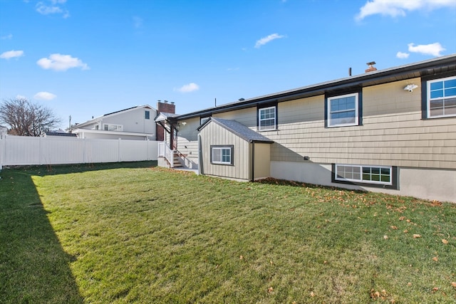 rear view of house with a yard