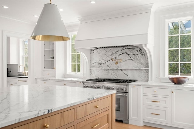 32 S Woodside Ave, Wellesley, MA 02482 - kitchen with stainless steel range, premium range hood, crown molding, light stone countertops, and decorative backsplash