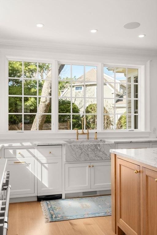 32 S Woodside Ave, Wellesley, MA 02482 - interior space featuring healthy amount of natural light, light wood-style floors, ornamental molding, and a sink