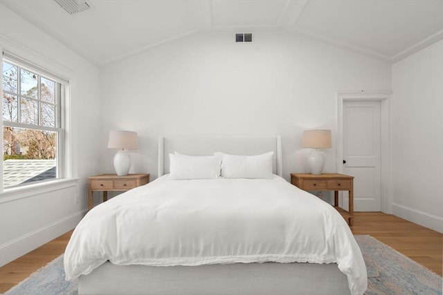 32 S Woodside Ave, Wellesley, MA 02482 - bedroom featuring wood finished floors, multiple windows, baseboards, and lofted ceiling