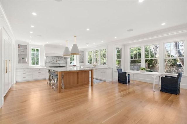32 S Woodside Ave, Wellesley, MA 02482 - kitchen featuring ornamental molding, decorative backsplash, white cabinets, light wood finished floors, and recessed lighting
