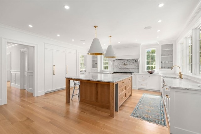 32 S Woodside Ave, Wellesley, MA 02482 - kitchen with a sink, crown molding, tasteful backsplash, light wood-style floors, and white cabinetry