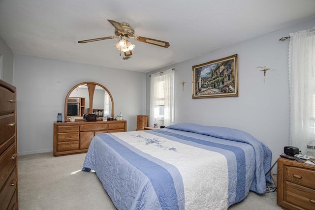 bedroom with ceiling fan and light colored carpet