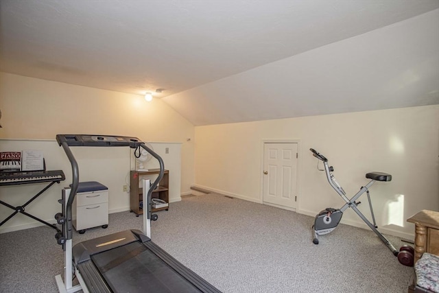 exercise area with vaulted ceiling and carpet