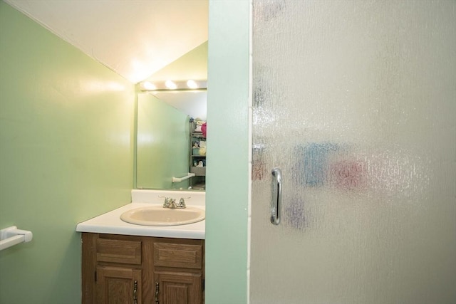 bathroom with vanity, an enclosed shower, and vaulted ceiling