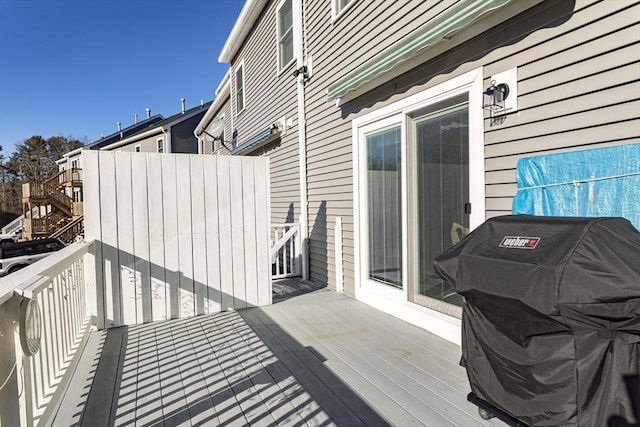 wooden deck featuring a grill