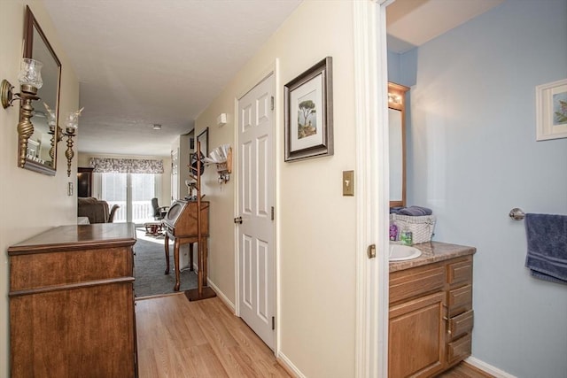 hall with light hardwood / wood-style flooring