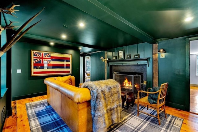 cinema room with a fireplace, recessed lighting, baseboards, and hardwood / wood-style floors