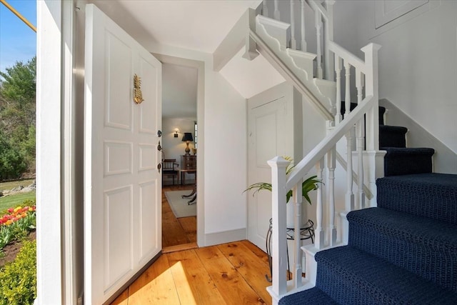 stairway with hardwood / wood-style flooring