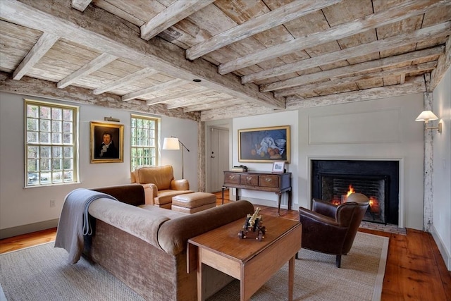 living area with a fireplace with flush hearth, wood finished floors, and wooden ceiling