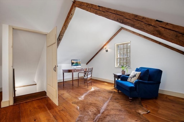 sitting room featuring lofted ceiling with beams and wood finished floors