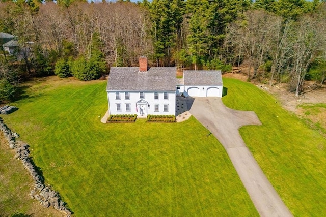 drone / aerial view with a wooded view