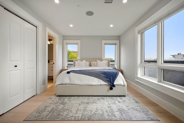 bedroom featuring light wood-type flooring and a closet