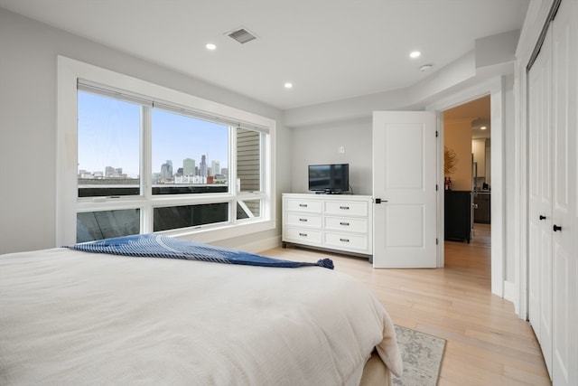 bedroom with a closet and light hardwood / wood-style floors