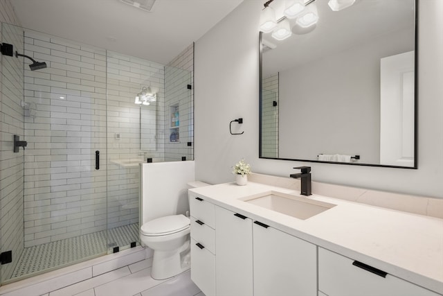 bathroom featuring tile patterned floors, a shower with shower door, vanity, and toilet