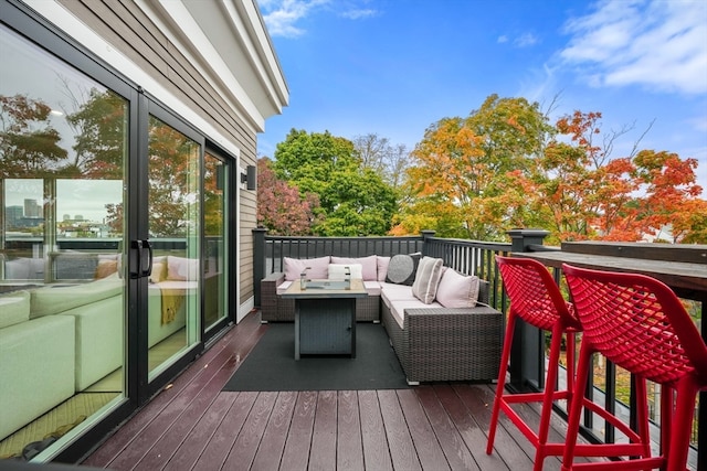 wooden terrace with an outdoor living space