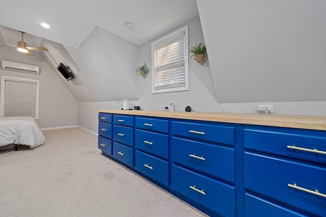 interior space with ceiling fan, a wall mounted air conditioner, and vaulted ceiling