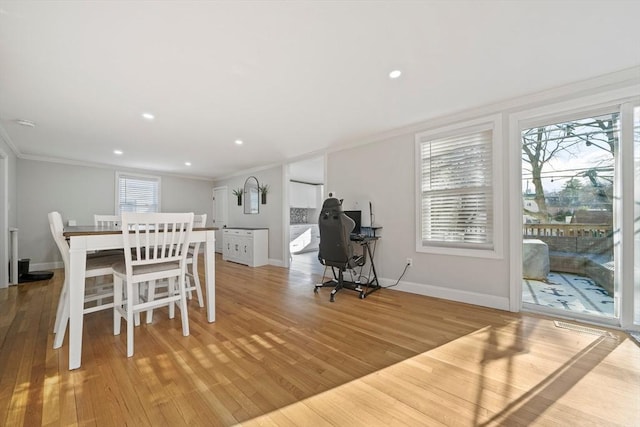 dining area featuring crown molding and light hardwood / wood-style floors