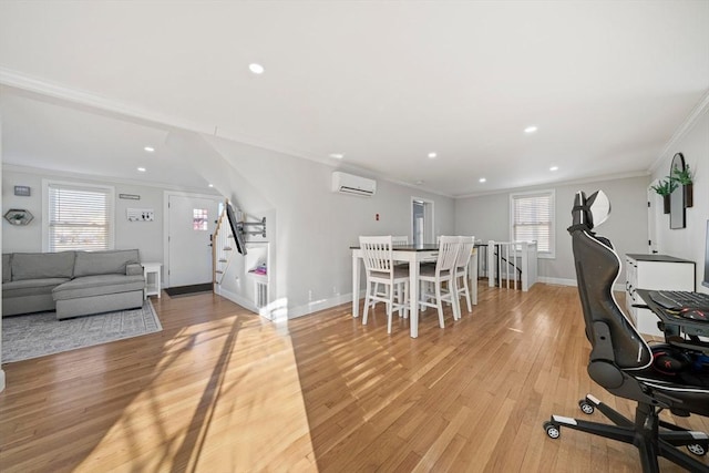 dining space featuring crown molding, a wall unit AC, and light wood-type flooring