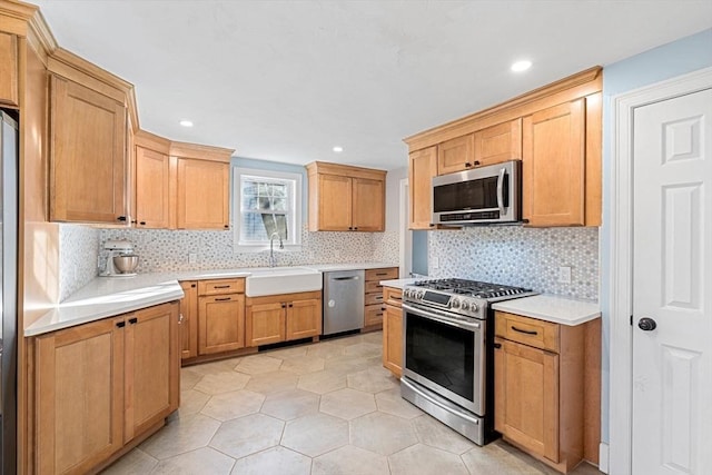 12 Babson St, Wakefield, MA 01880 - kitchen featuring appliances with stainless steel finishes, tasteful backsplash, light countertops, light tile patterned floors, and recessed lighting